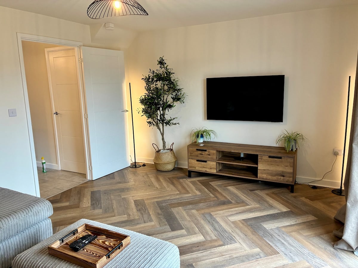 Fairwater House lounge with wall mounted Smart TV