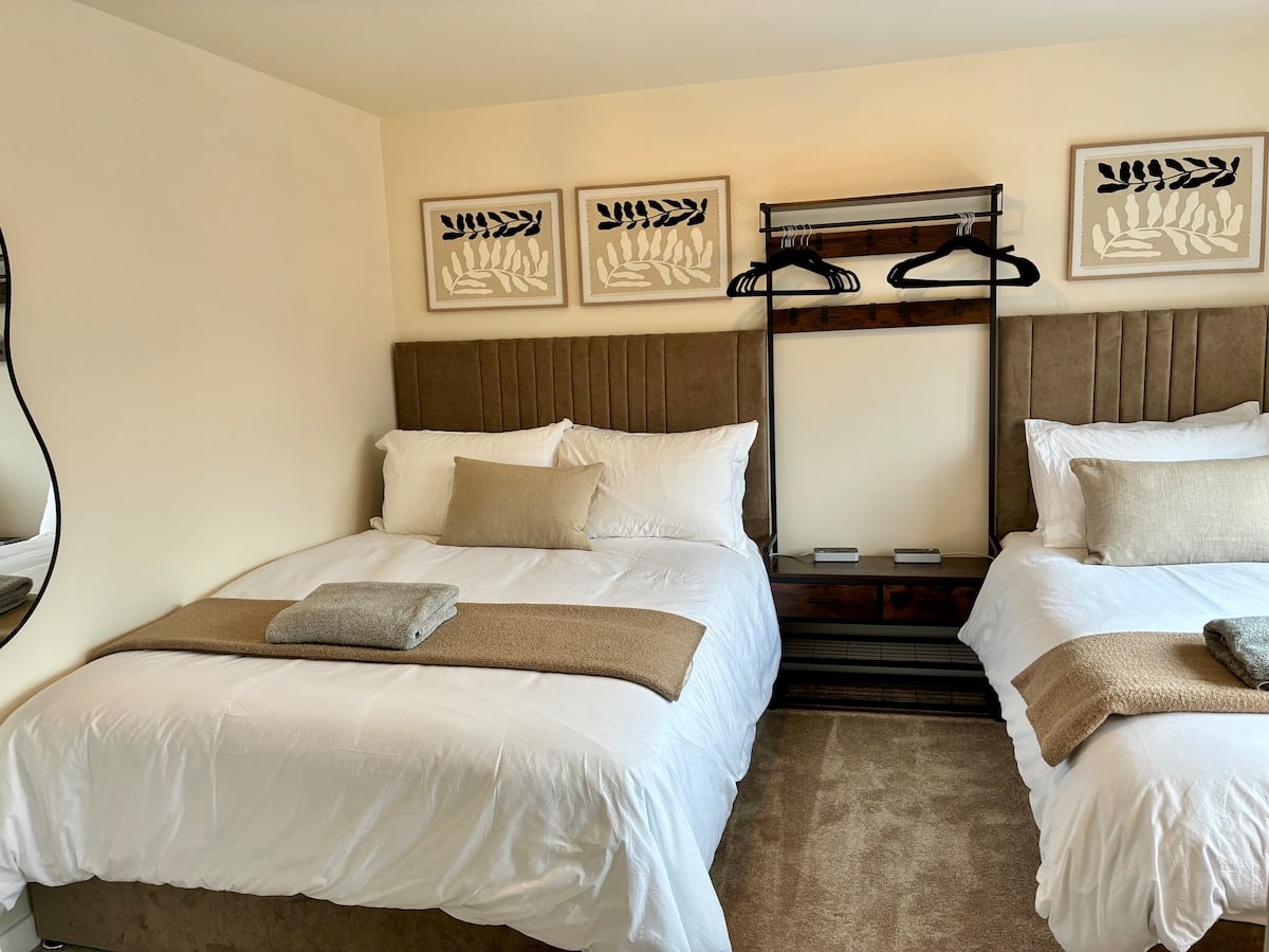 Bedroom 1 double bed with upholstered headboard at Fairwater House