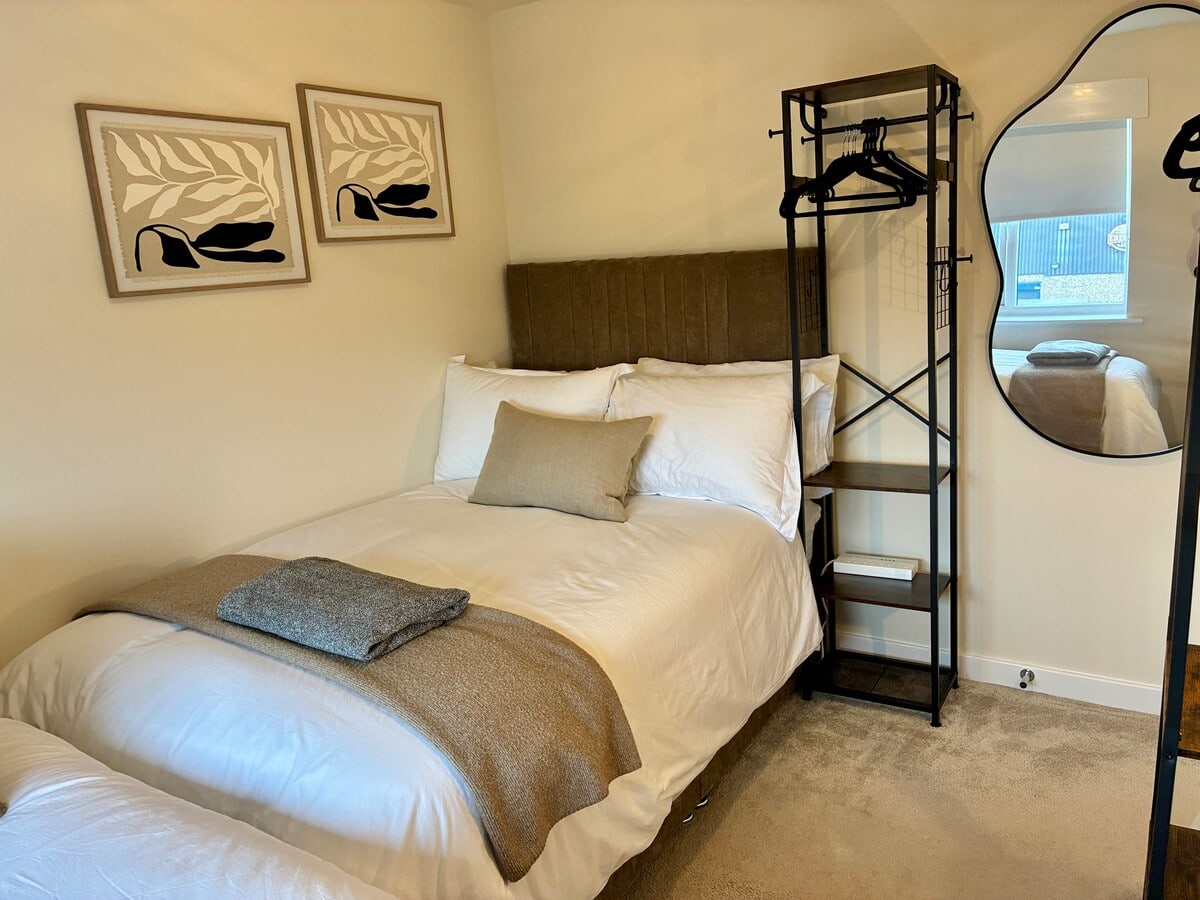 Bedroom 2 bed and clothes rail at Fairwater House