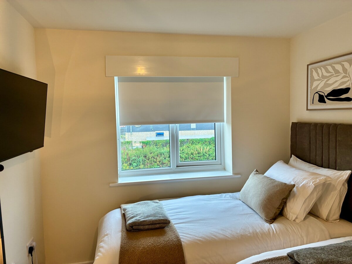 Bedroom 2 with blackout blind and Smart TV at Fairwater House