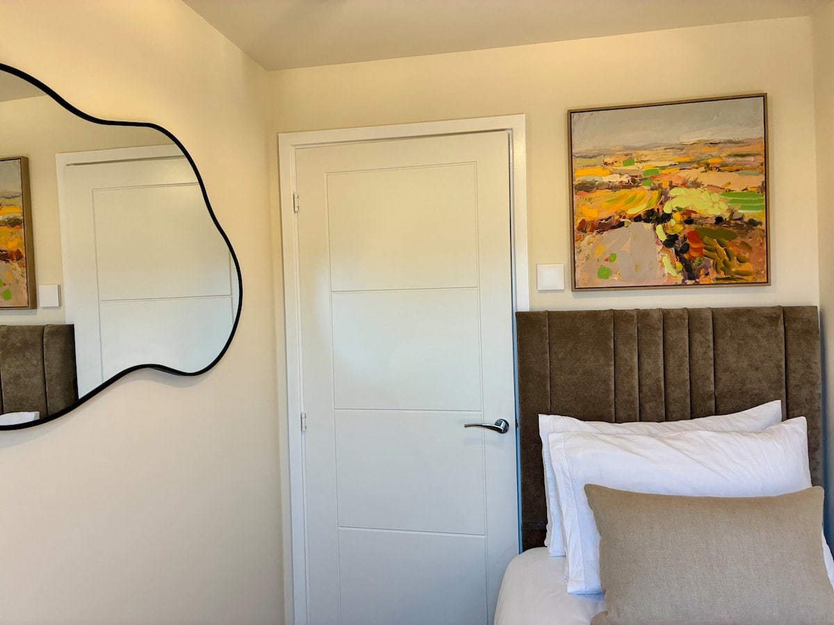 Bedroom 3 artwork and mirror at Fairwater House